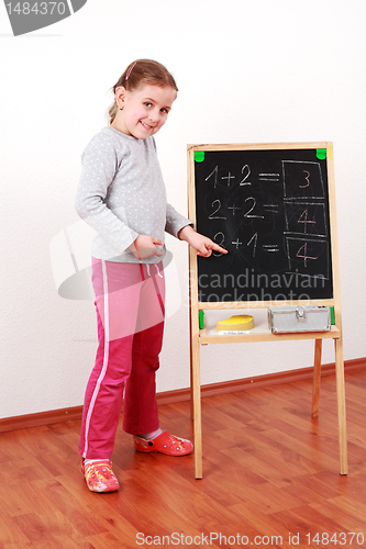 Image of Cute girl doing math