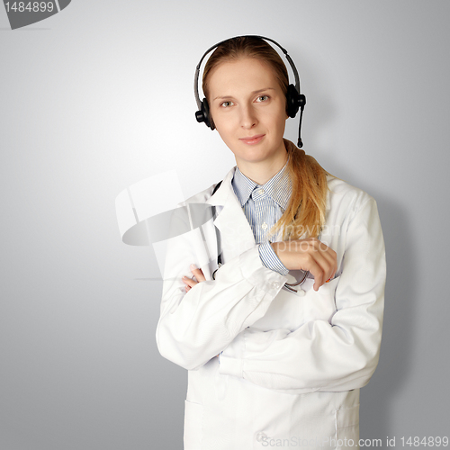 Image of doctor woman with headphones smile at camera