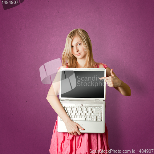 Image of femaile in pink with open laptop