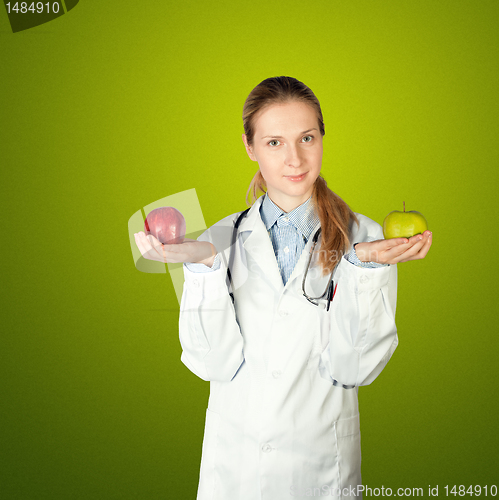 Image of female doctor with two apples
