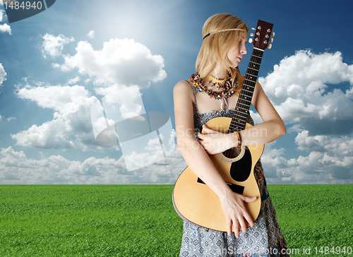 Image of hippie girl with the guitar outdoor