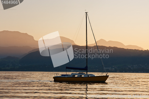 Image of Solitary yacht on the lake in a sunset