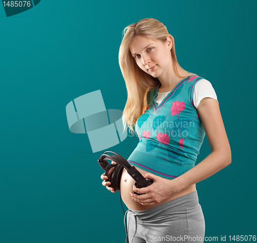 Image of pregnant female with headphones