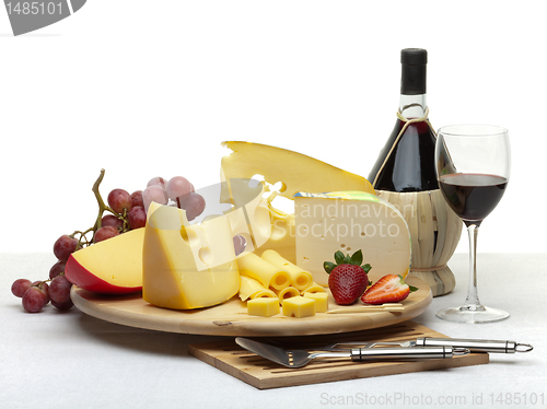 Image of Cheese still life on a wooden round tray