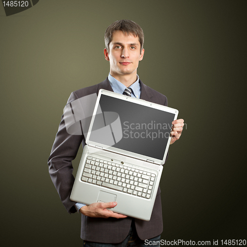 Image of businessman with open laptop in his hands