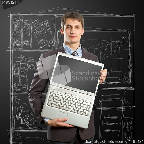 Image of businessman with open laptop in his hands