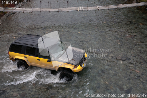 Image of jeep crossing a river