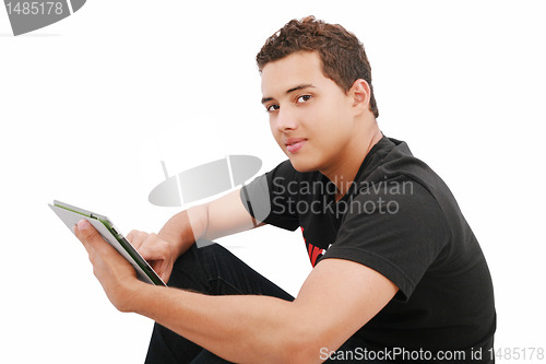 Image of A smiling man sitting on the floor with a tablet, isolated on wh