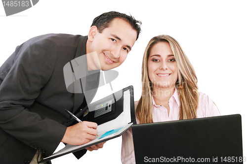 Image of Cheerful business people working on a laptop during a meeting