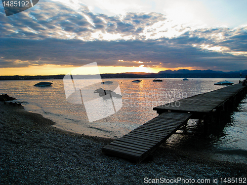 Image of Sunset over Lago di Garda, Italy with Boats and Dock