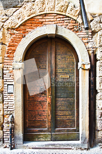 Image of Old Wooden Door with Letter Slot in Italy