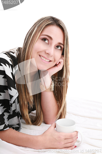 Image of Smiling woman laying on bed 