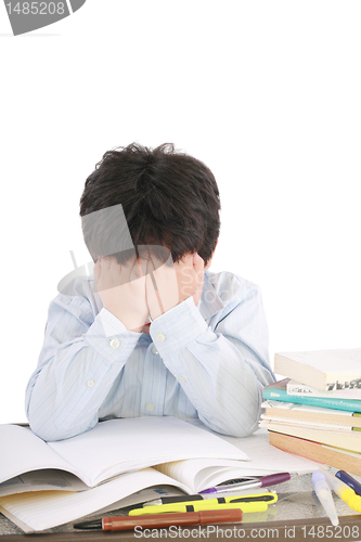 Image of Stressed schoolboy studying in classroom 