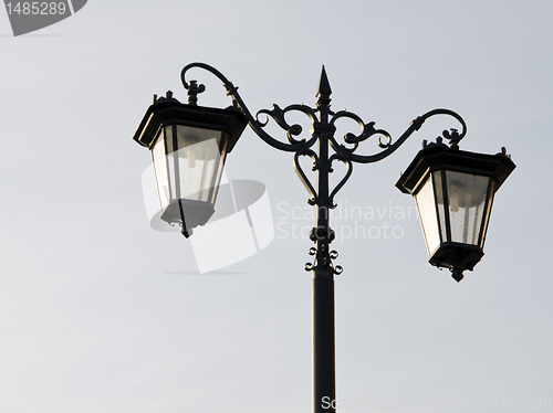 Image of Old town street illuminator. Lamps hanging on pole
