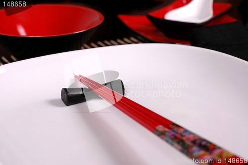 Image of Red chopsticks on white plate