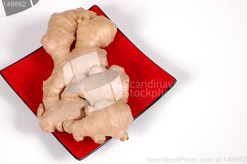 Image of Hand of ginger on red plate