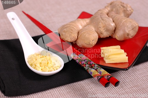 Image of Hand of ginger with minced and sliced ginger