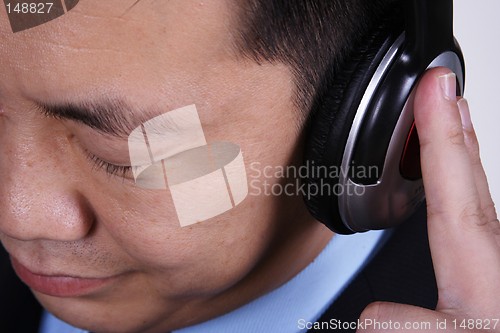 Image of Asian businessman listening