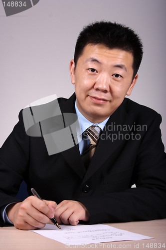 Image of Asian Businessman Writting