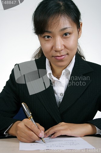 Image of Asian Businesswoman Writting