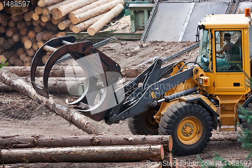 Image of Skidder hauling logs at sawmill.