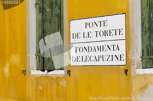 Image of Green shutters and yellow wall