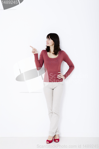 Image of Beautiful woman standing and pointing