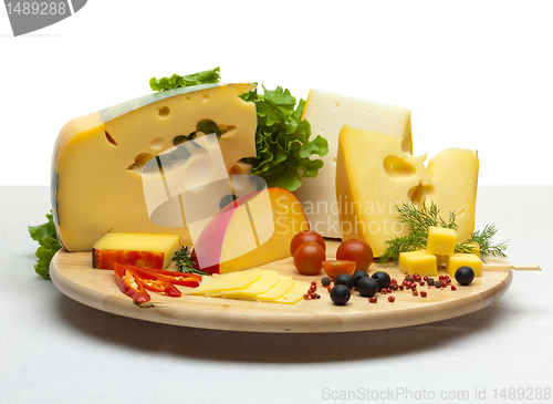 Image of Cheese still life on a wooden round tray