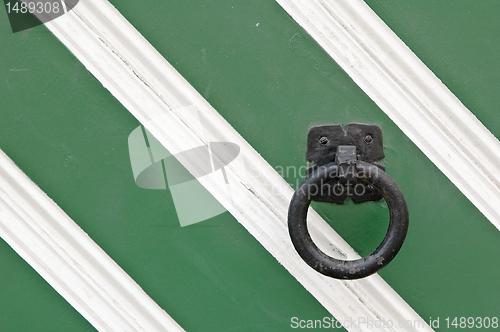 Image of old pattern gate with a knocker