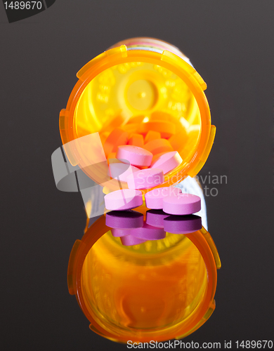 Image of Purple pills from orange drug bottle