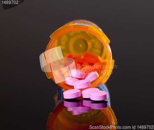 Image of Purple pills from orange drug bottle