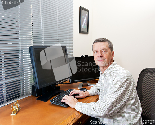 Image of Senior man at computer desk