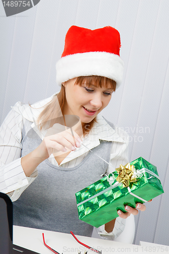 Image of Girl in the office with a New Year gift