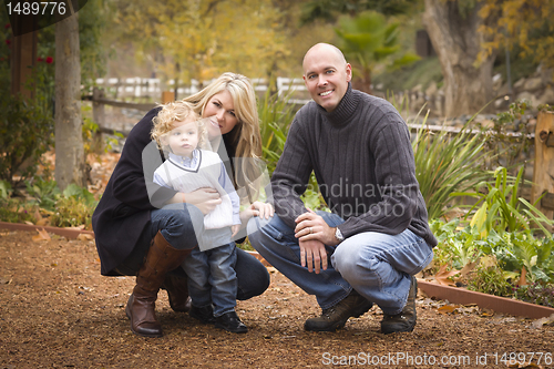 Image of Young Attractive Parents and Child Portrait in Park