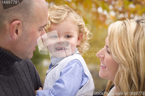 Image of Young Attractive Parents and Child Portrait in Park