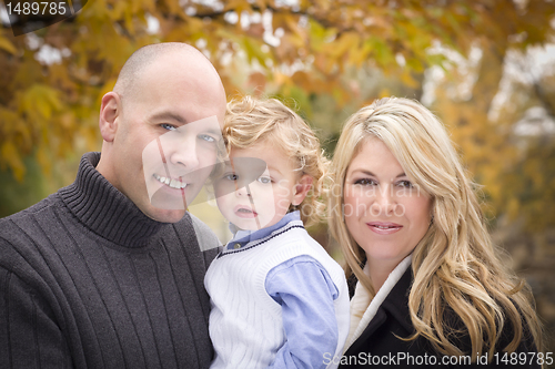 Image of Young Attractive Parents and Child Portrait in Park