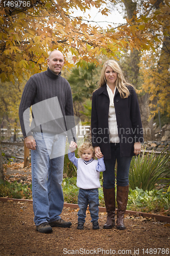 Image of Young Attractive Parents and Child Portrait in Park