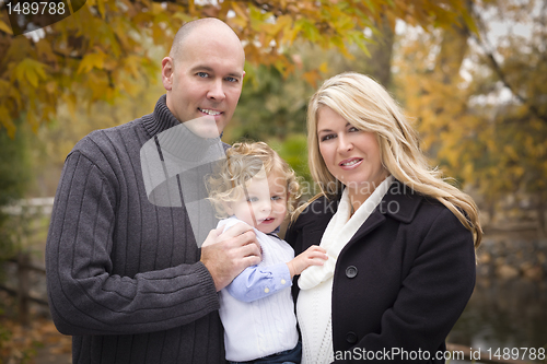 Image of Young Attractive Parents and Child Portrait in Park