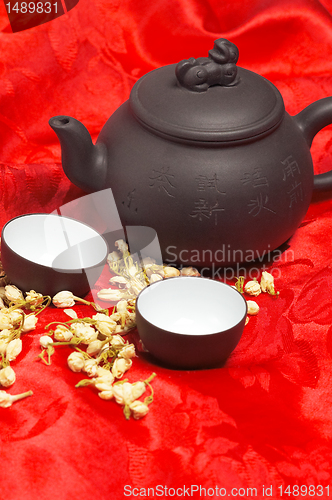 Image of jasmine tea over red silk