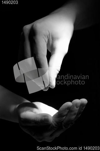 Image of Hand giving  to another hand on foto