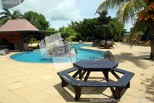 Image of Table, poolo and palm trees