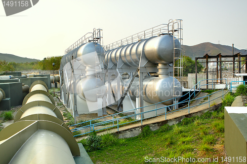 Image of oil tanks and pipes outdoor at day 