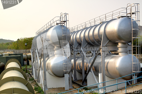 Image of oil tanks and pipes outdoor at day 