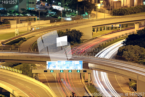 Image of Freeway in night with cars light in modern city. 