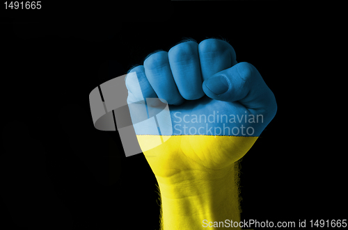 Image of Fist painted in colors of ukraine flag