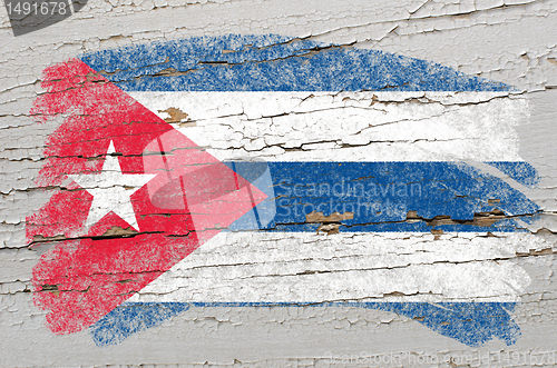 Image of flag of cuba on grunge wooden texture painted with chalk  