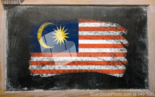 Image of flag of Malaysia on blackboard painted with chalk  