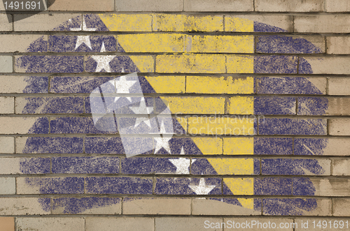 Image of flag of bosnia and herzegovina on grunge brick wall painted with