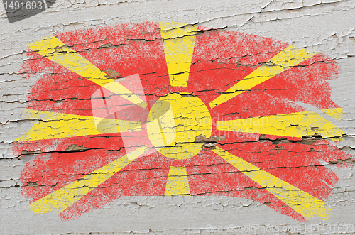 Image of flag of macedonia on grunge wooden texture painted with chalk  