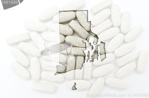 Image of Outline map of rhode island with transparent pills in the backgr